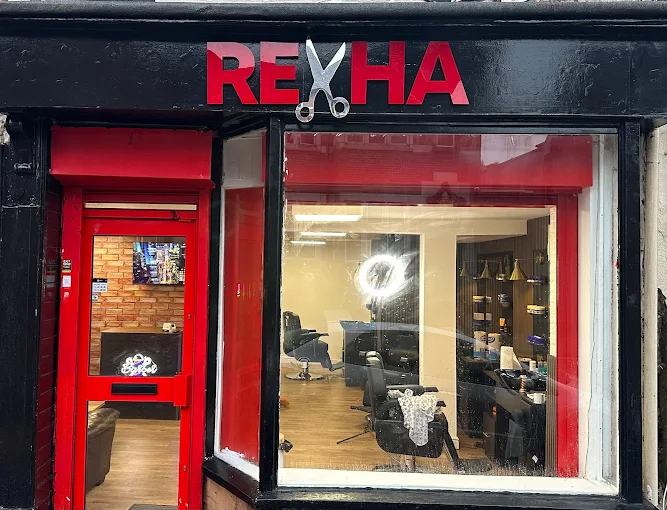 Inside Rexha Barbers with styling chairs and mirrors